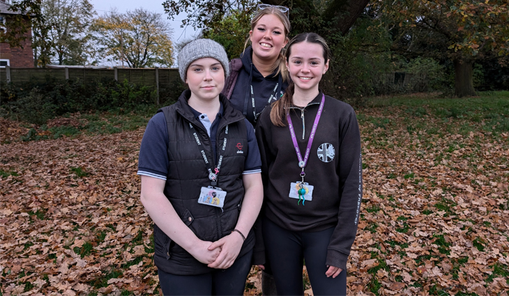 Equine students in front of tree