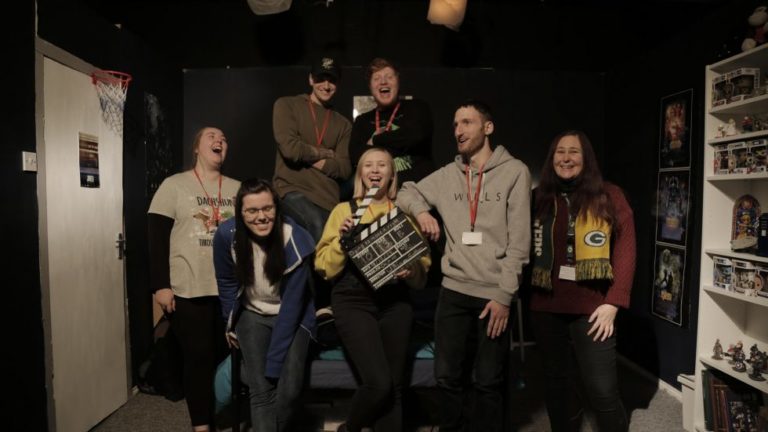 HE Media students smiling after wrapping up filming