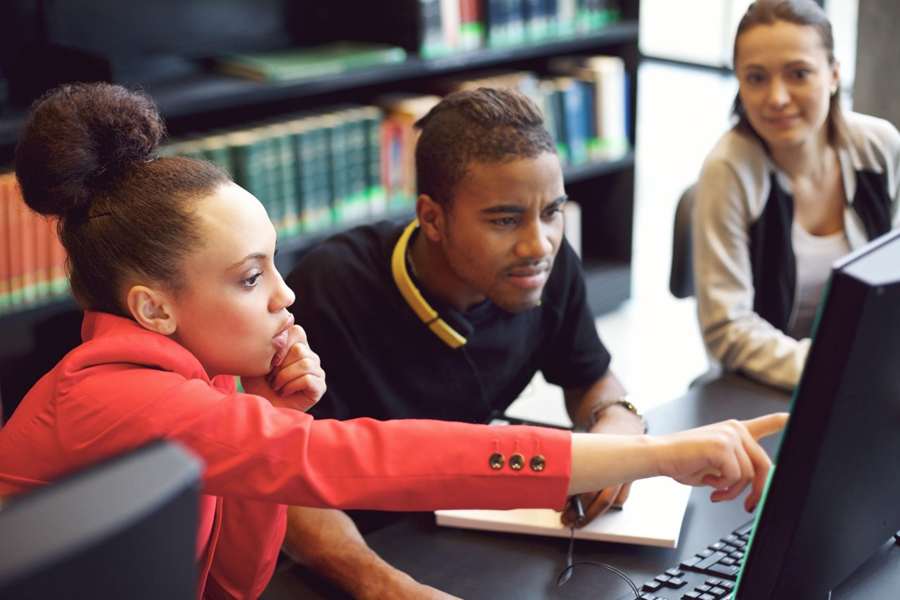Learners around a computer