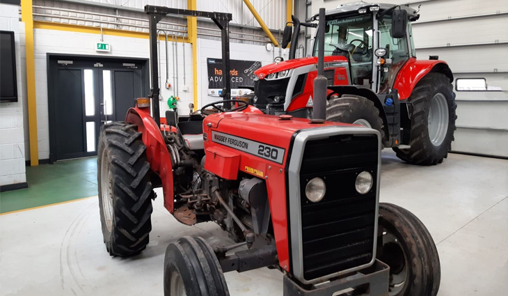 Two red tractors in workshop