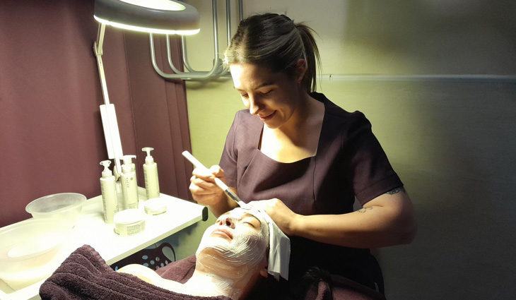Photo of adult beauty learner performing a facial massage