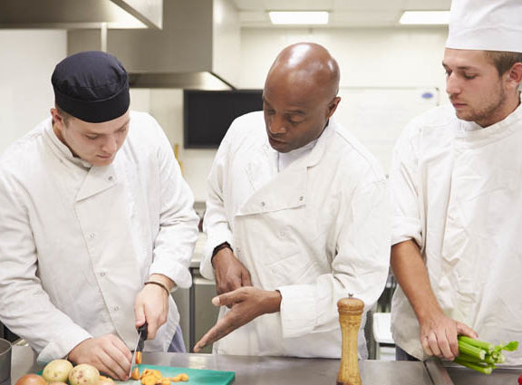 Three men cooking