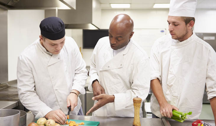 Three men cooking