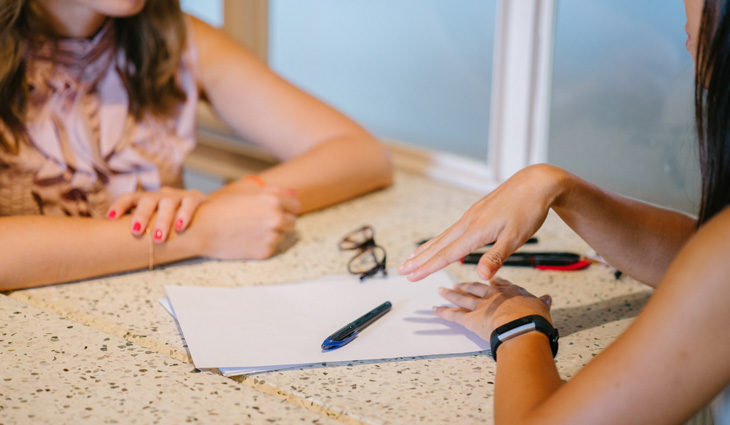 Counsellor and patient talking across table