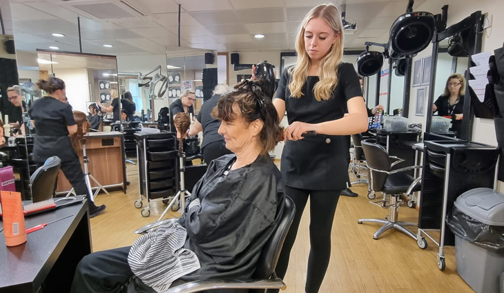 Photo of level 2 hairdresser Elle-May cutting hair