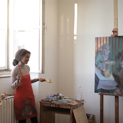 Female artist standing in studio