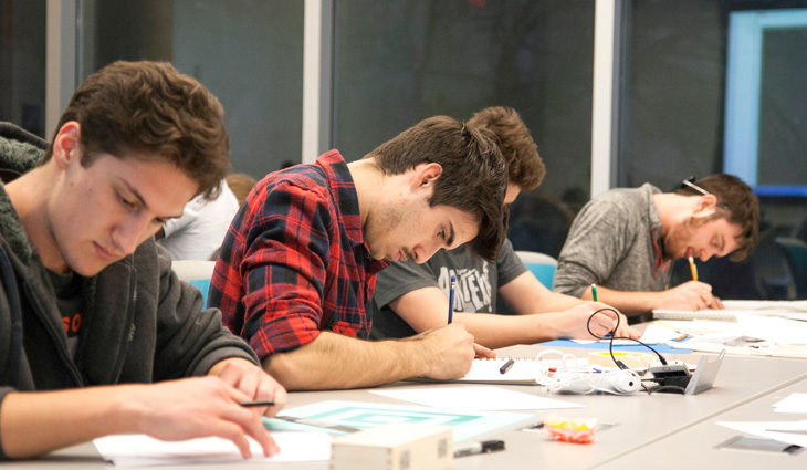 Group of learners writing at a table