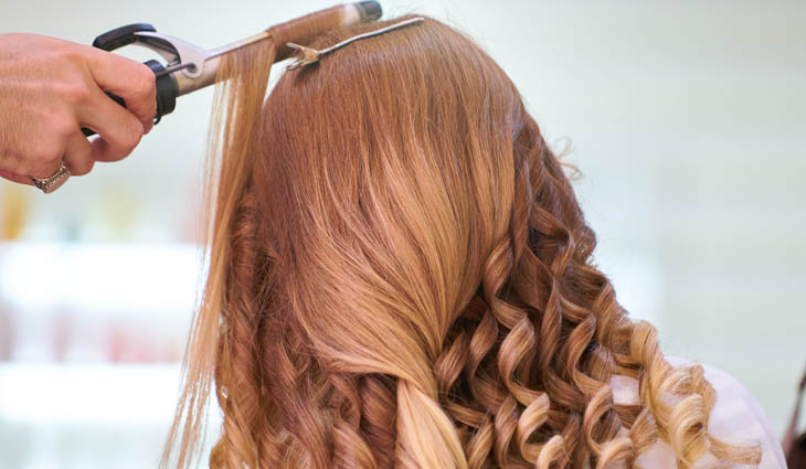 Woman getting her hair curled