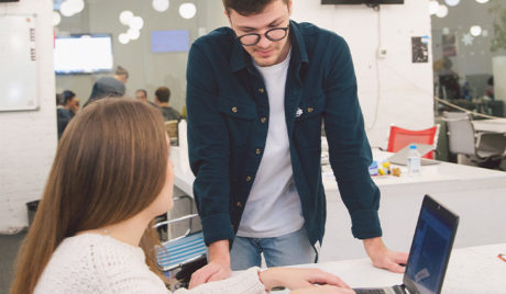 Students talking over a laptop