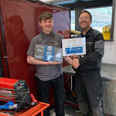 Agricultural Engineering student Jay Cartwright shaking hands with lecturer Jamie Youngs