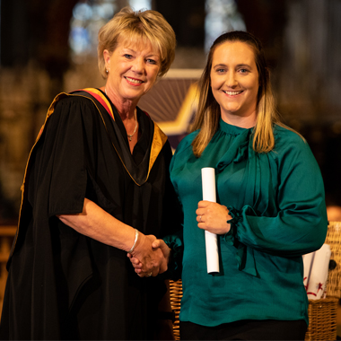 Karina Oliver shaking hands with Claire Boliver at student awards