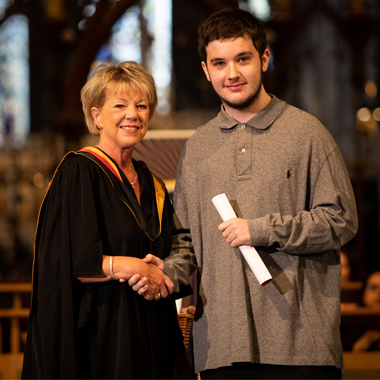 Photo of Lee Hollyhead shaking hands with Claire Boliver at Student Awards