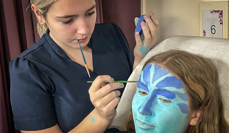 Photo of a Level 1 Beauty Therapy student painting another student's face