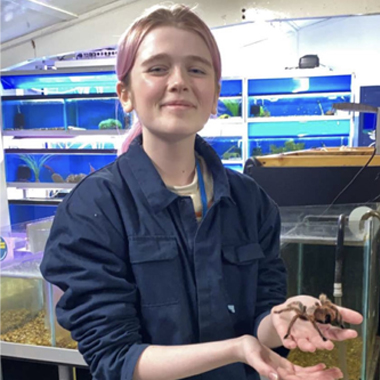 Photo of student Milli Price holding a tarantula