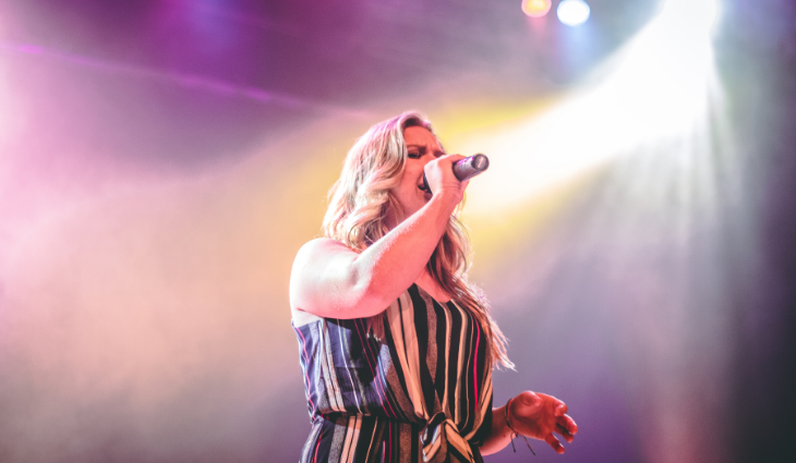 Woman singing on stage