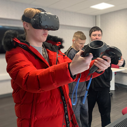 Students playing with VR glasses at an open day