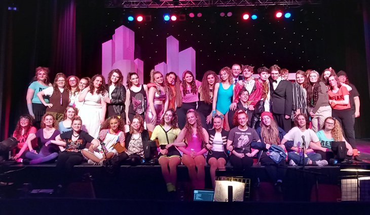 Group photo of our Performing Arts students on stage at the end of their show