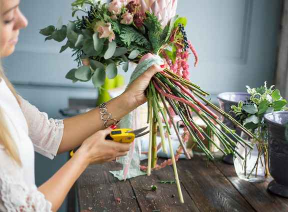 Person using secateurs on flowers