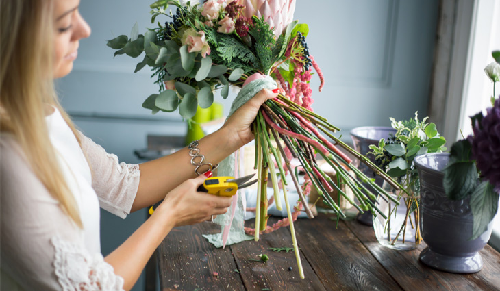 Person using secateurs on flowers
