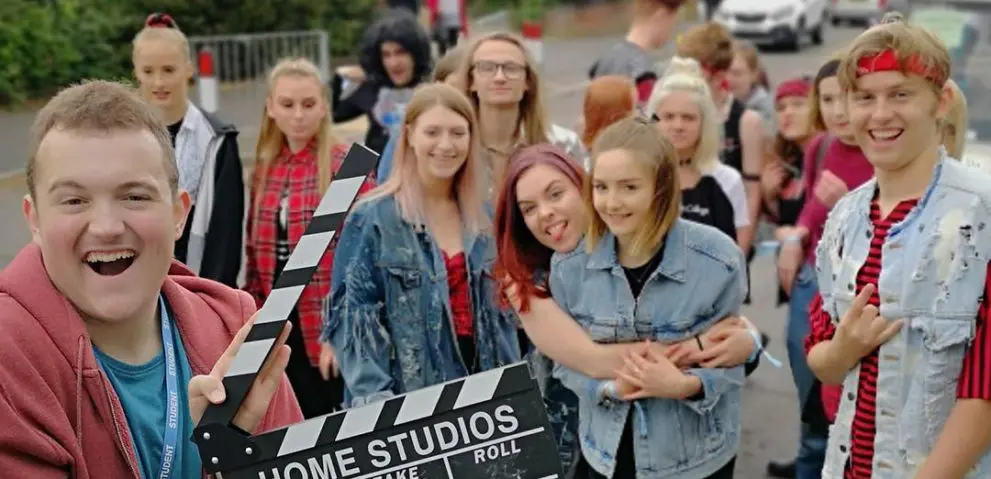 Students smiling and posing at the camera