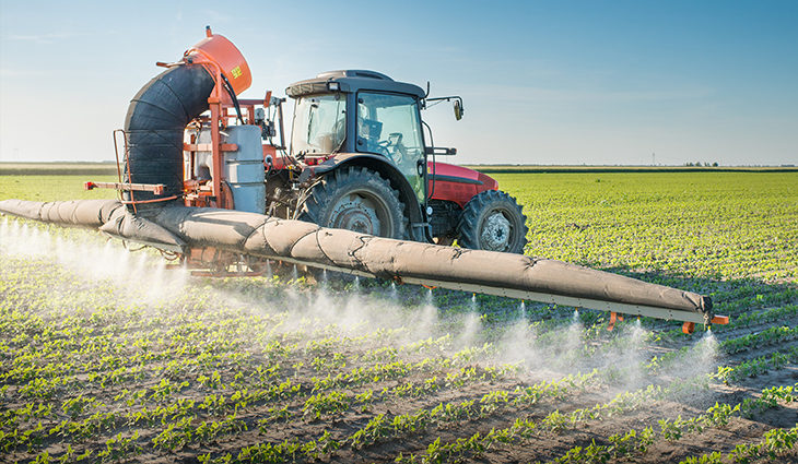 Tractor and PA2 sprayer spraying a field