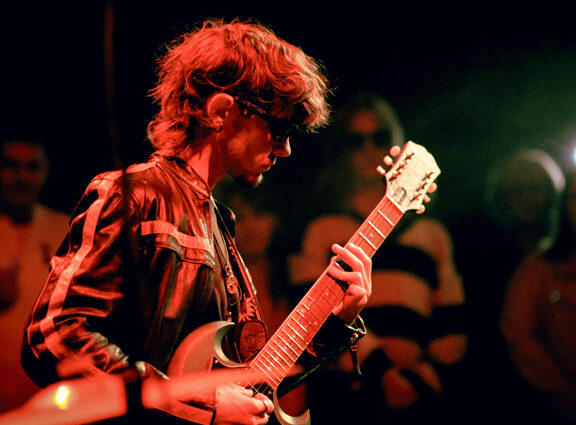 Student playing guitar at Introducing Nights