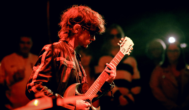 Student playing guitar at Introducing Nights