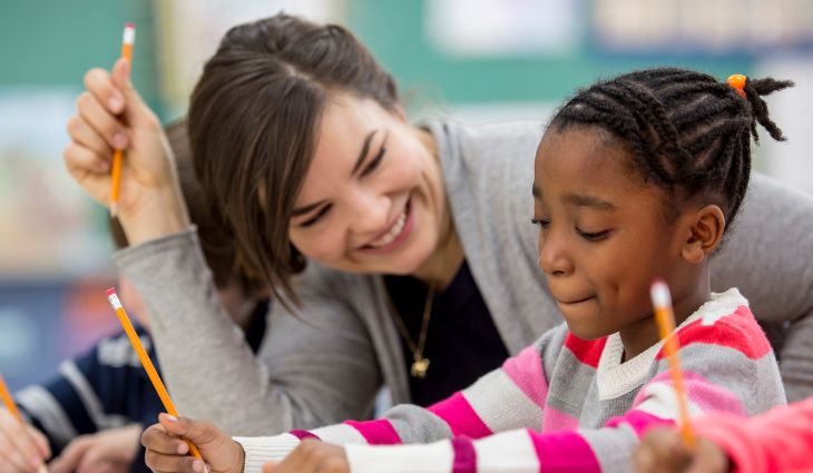 Teaching assistant helping student in class