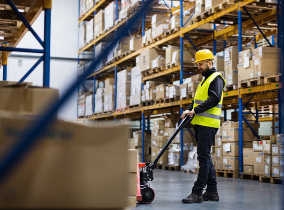 A male wearing a high-viz in a warehouse