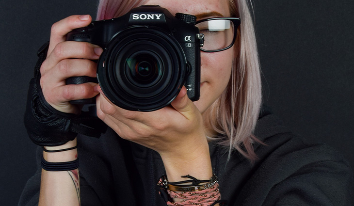 Close up of a student holding a camera