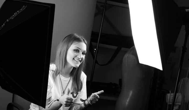 A student in the photography studio with lighting