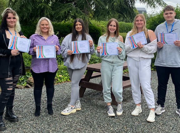 Business students holding certificates at Lichfield