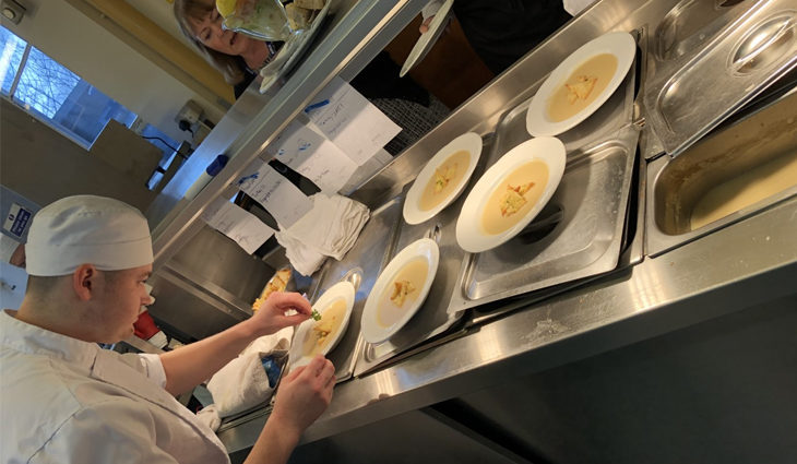 Catering student preparing dishes in the kitchen
