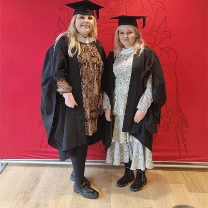 Photo of two students at graduation