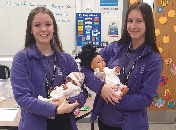 Level 2 Early Years students at Cannock holding babies