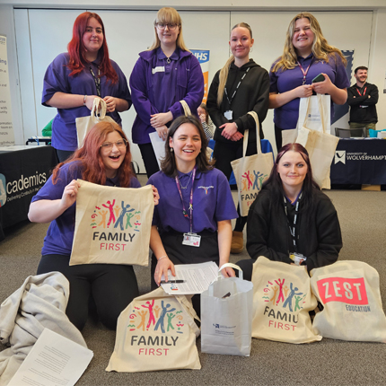 Early Years students with merch at employer event