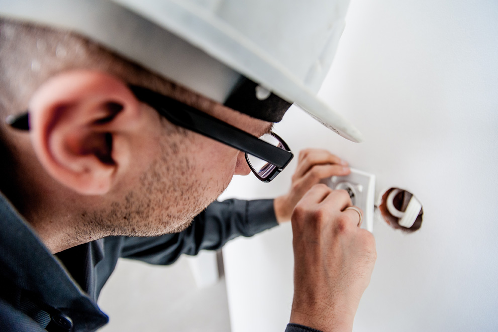 Electrician working on a socket 991x661