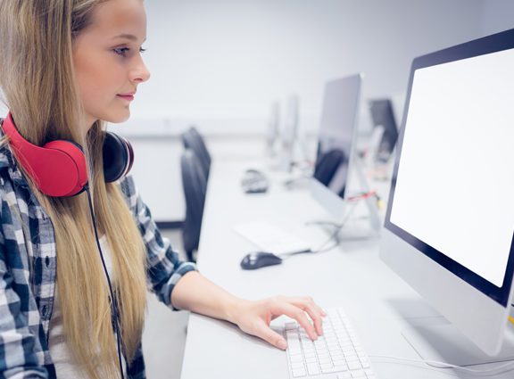 Girl wearing headphones working on a computer