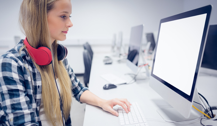 Girl wearing headphones working on a computer