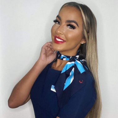 Photo of former Travel and Tourism student Holly Burns wearing TUI uniform