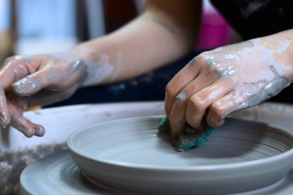 Person using pottery wheel 991x661