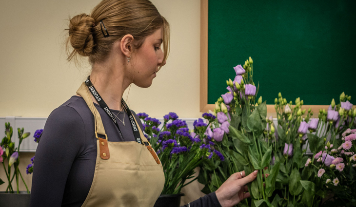 Photo of Floristry student Katie Rowley picking flowers