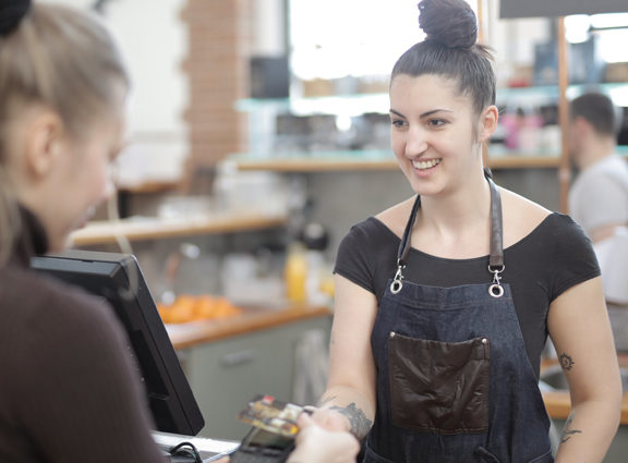 Woman serving customer in a retail environment