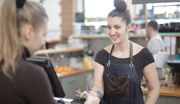 Woman serving customer in a retail environment