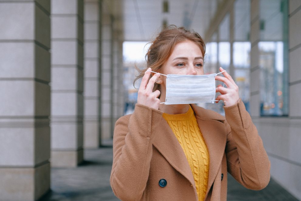 Girl putting face mask on