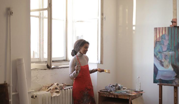 Female artist standing in studio