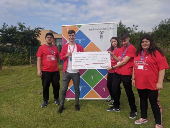Princes Trust students receiving cheque from Birmingham Children's Hospital