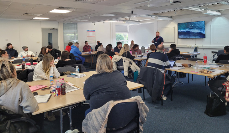 Photo of former student Matt Stockin doing a careers presentation to current students