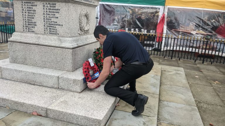 Cannock public services student laying a wreath in Cannock town centre on Remembrance Day 2022