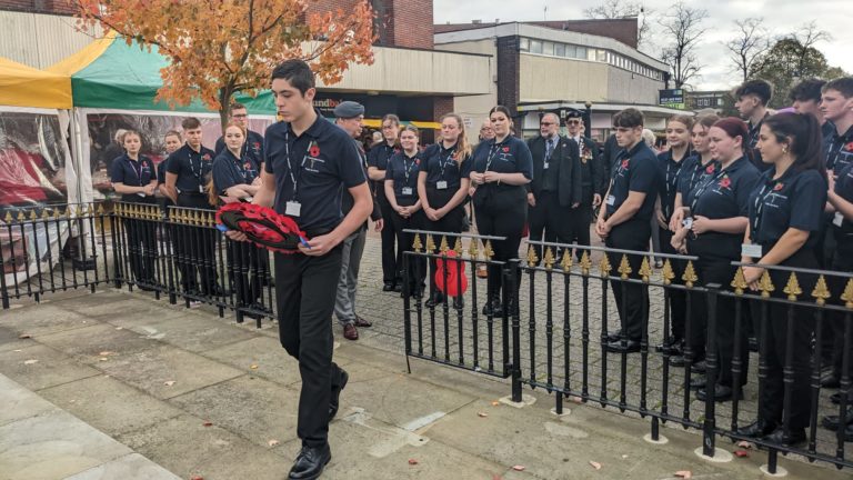 Cannock public services student laying a wreath in Cannock town centre